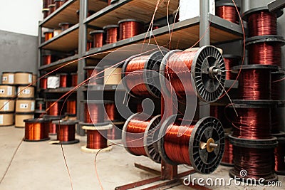 Many coils of copper wire in the production workshop, winding copper cable on spools Stock Photo