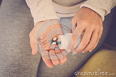 Many colored pills in a womans`s hands.. Caring for the health of the elderly - drugs depressing female Stock Photo
