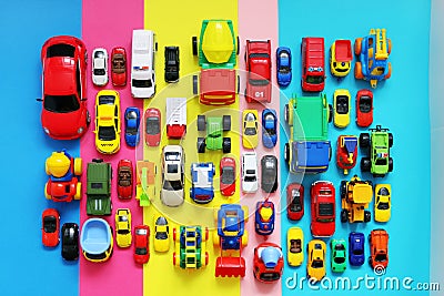 Many colored toy cars on multicolored background Stock Photo