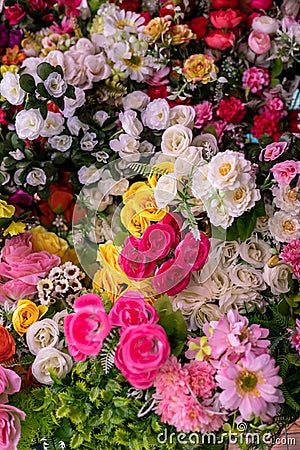 Many colorful artificial fake flowers background blooming beautiful Stock Photo