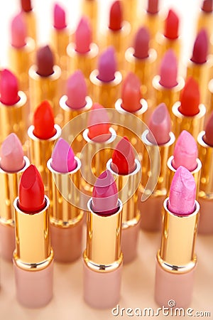 Many colorful lipstick on beige background, close up Stock Photo