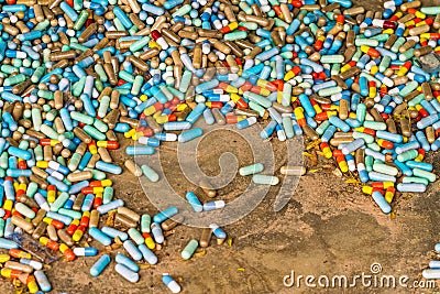 Many colorful medicines expire on cement floor Stock Photo