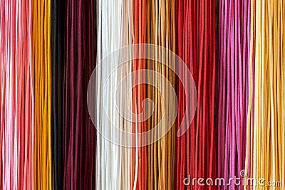 Many colorful multicolored leather shoelaces hang vertically close up on the Eastern Bazaar. Editorial Stock Photo