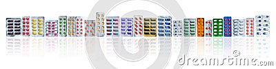 Many of colorful pills in blister packs in a row on white background with copy space. Pharmaceuticals industry. Stock Photo