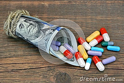 Many Colorful Pills And Capsules Dropped From Money Roll Stock Photo