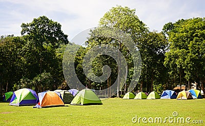 Many colorful Tents on the grass fields at Huay Kamin Waterfall Stock Photo