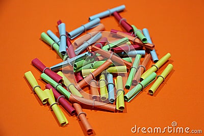 Many colorful tombola tickets lie on an orange underground Stock Photo