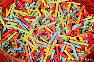 Many colorful tombola tickets are lying in a bowl Stock Photo