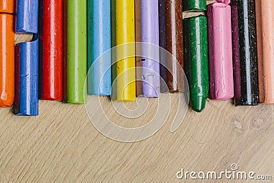 Many colourful used crayon in a row Stock Photo