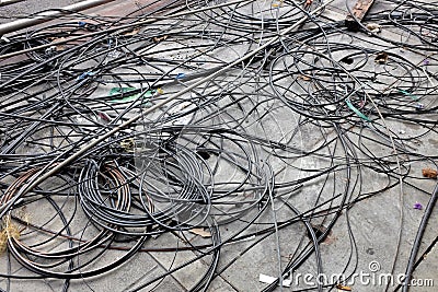 Many confused electrical wires on ground Stock Photo