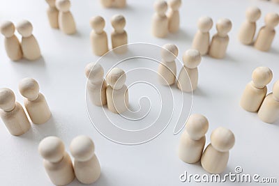 Many couples of female and male wooden people figures on white background. Stock Photo