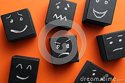 Many cubes with different emotions on background, flat lay. Emotional management Stock Photo