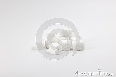 Many cubes of white regular sugar in a heap on a light background Stock Photo