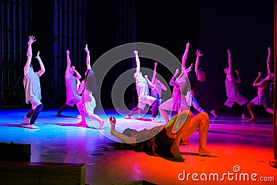 Contemporary dancers on the stage hands and looks up Editorial Stock Photo