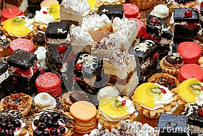 Many delicious cakes and cupcakes on table at luxury wedding rec Stock Photo