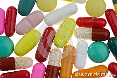 Many different colored tablets and medicines Stock Photo