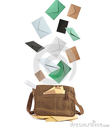 Many different envelopes falling into brown postman`s bag on white background Stock Photo