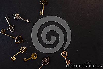 Many different old keys from different locks, scattered chaotically, flat lay. Stock Photo