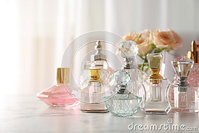 Many different perfume bottles on dressing table Stock Photo