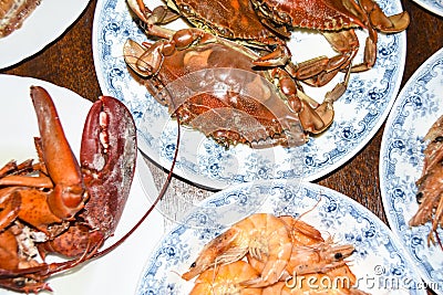 Many different seafood lobster shrimp octopus crabs dish lie on meze plates Stock Photo