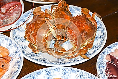 Many different seafood lobster shrimp octopus crabs dish lie on meze plates Stock Photo