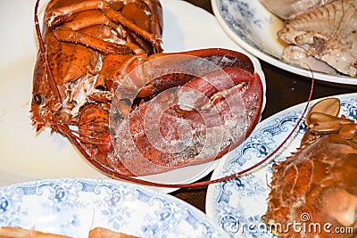 Many different seafood lobster shrimp octopus crabs dish lie on meze plates Stock Photo