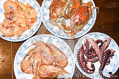 Many different seafood lobster shrimp octopus crabs dish lie on meze plates Stock Photo
