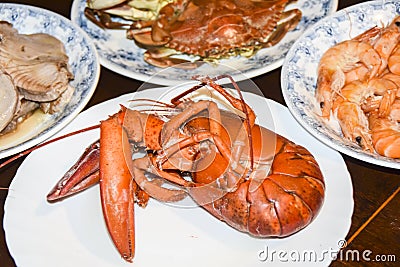 Many different seafood lobster shrimp octopus crabs dish lie on meze plates Stock Photo