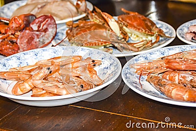 Many different seafood lobster shrimp octopus crabs dish lie on meze plates Stock Photo