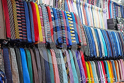 Many different ties of multi colors on display at the exhibition showcase. Large assortment of items for customers to choose from Stock Photo