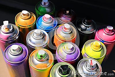 Many different used cans of spray paint, above view. Graffiti supplies Stock Photo