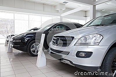 Many different used cars are in the dealership of a dealer accepted by the trade-in system during a sale in a bright room with Stock Photo