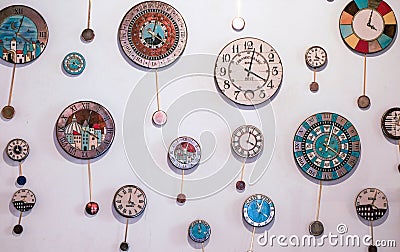 Many different wall clock on the wall Stock Photo