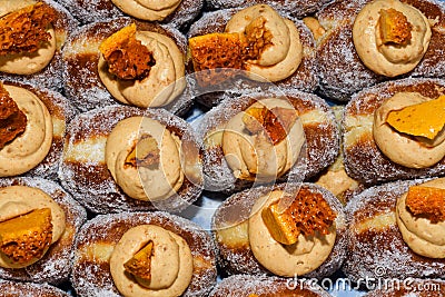 Many donuts placed in a tray, for sale at food market Stock Photo