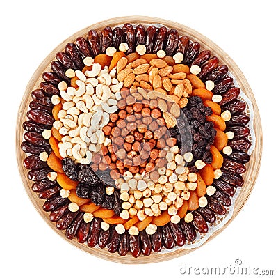 Many dried fruits on a round plate with nuts Stock Photo