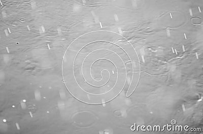 Many drops of hail and rain with fast speed break on the water surface of the river Stock Photo