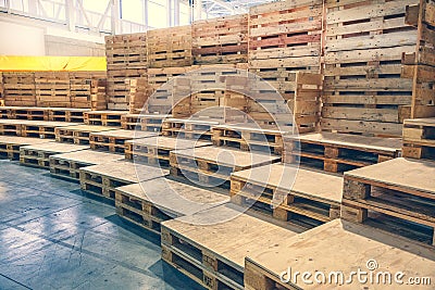 Many empty pallets stored in warehouse Stock Photo