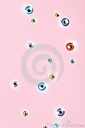 Many eyes on pink background Stock Photo