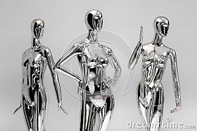 many fashion shiny female mannequins for clothes. Metallic manne Stock Photo