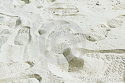 Many footprints on the white sand or beach. Stock Photo