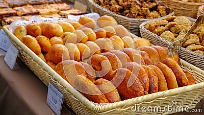 Many freshly baked buns in the basket. Top view bread. Pies freshly baked at the home producers' market Stock Photo