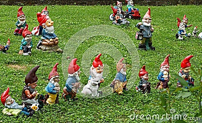 Many garden gnomes on grass Stock Photo
