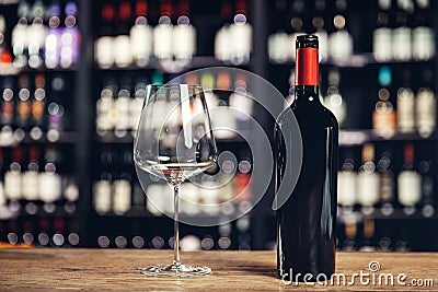 Many glass wine bottles on shelves interior in restaurant. Blurred background Stock Photo