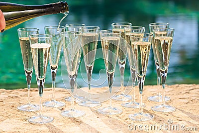 Many glasses of champagne or prosecco near resort pool in a luxury hotel. Pool party. Stock Photo