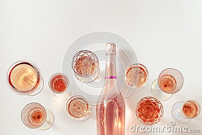 Many glasses of rose wine and bottle sparkling pink wine top view. Light alcohol drink for party. Stock Photo