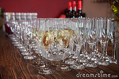 Many glasses with white wine on buffet table. Soft focus, selective focus Stock Photo