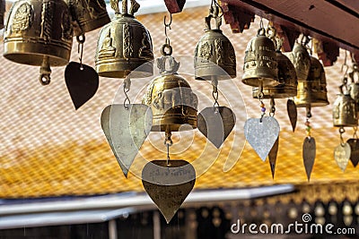 Golden buddhist bells with wishes in sunlight Stock Photo