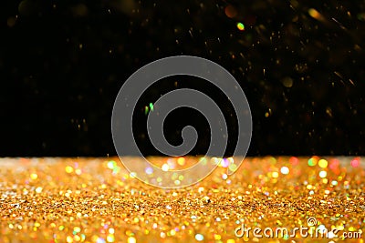 Many golden paillettes against black background Stock Photo
