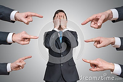 Many hands are pointing on guilty man and blame him Stock Photo