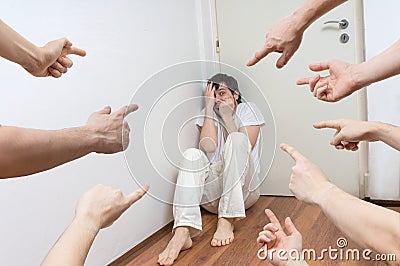 Many hands pointing on paranoid man and blame him Stock Photo